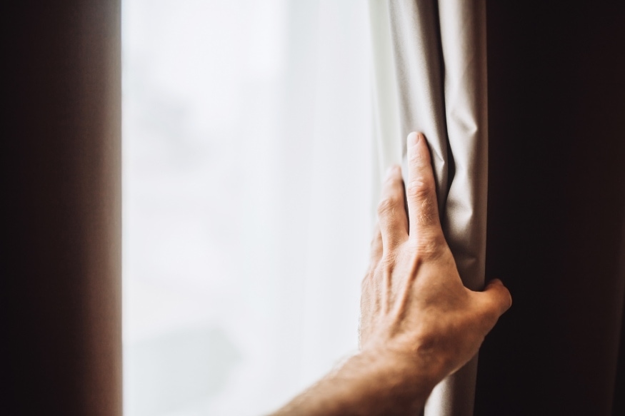 a hand opening blackout curtains