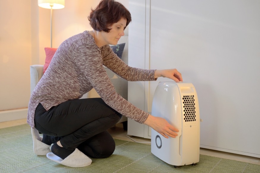 a person setting up a dehumidifier