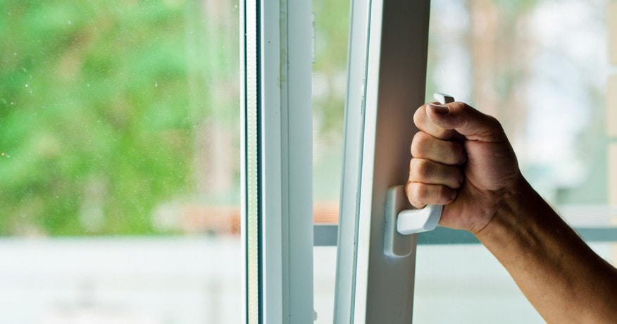 A person opening the window while the AC is on