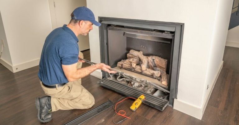 A technician checking the electric fireplace