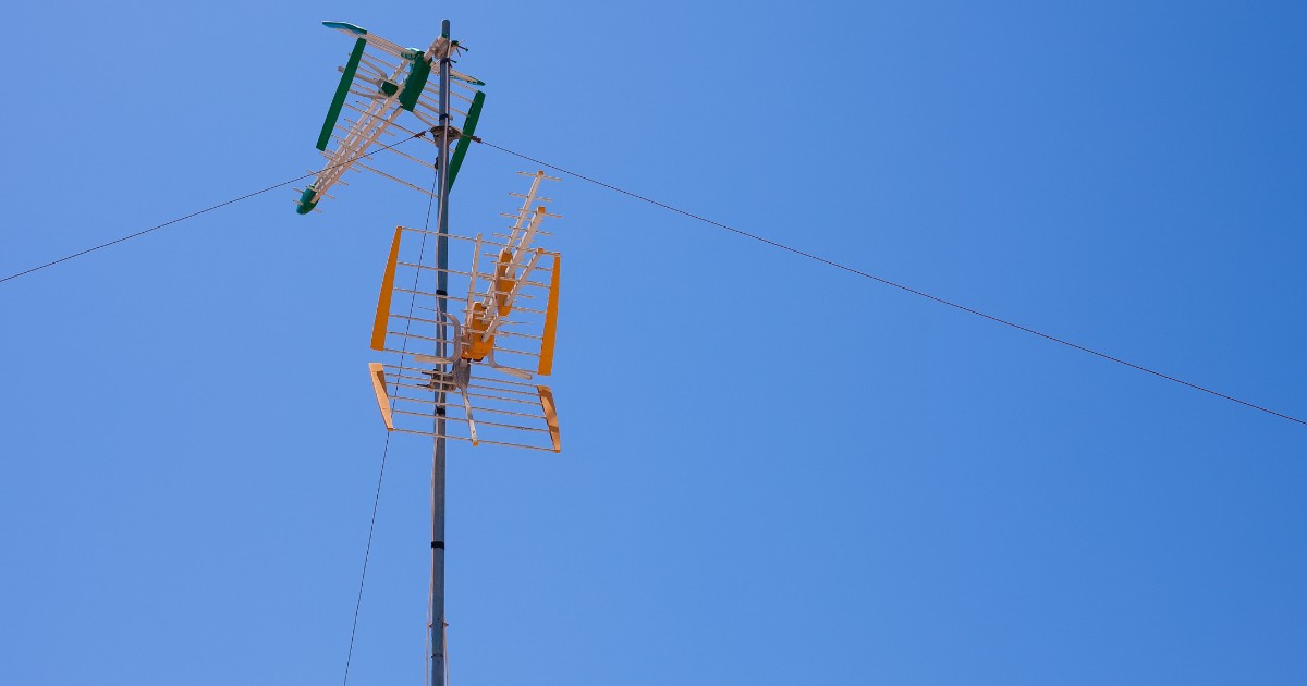 two tv antennas on a high mast